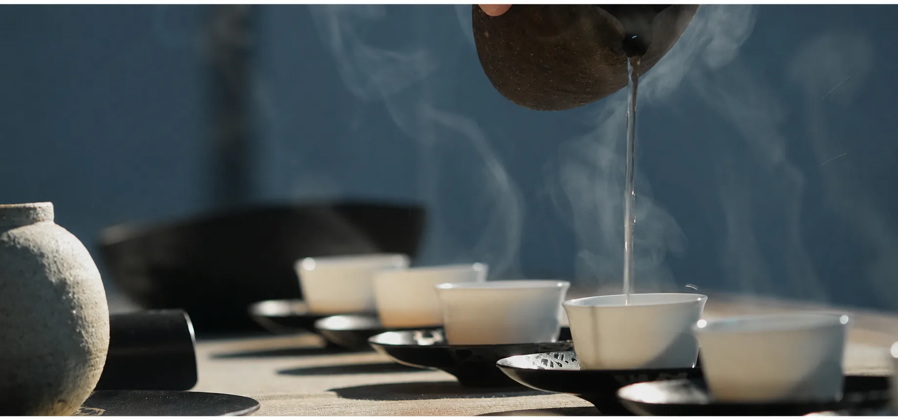 Tea being poured into porcelain cups